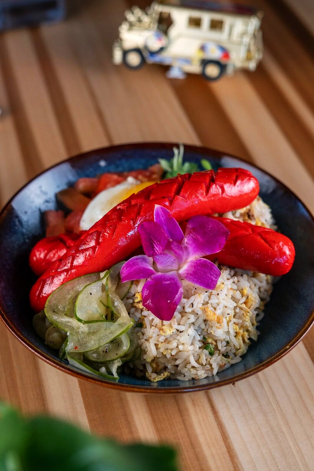 A Filipino silog brunch plate with sunny-side egg and garlic rice