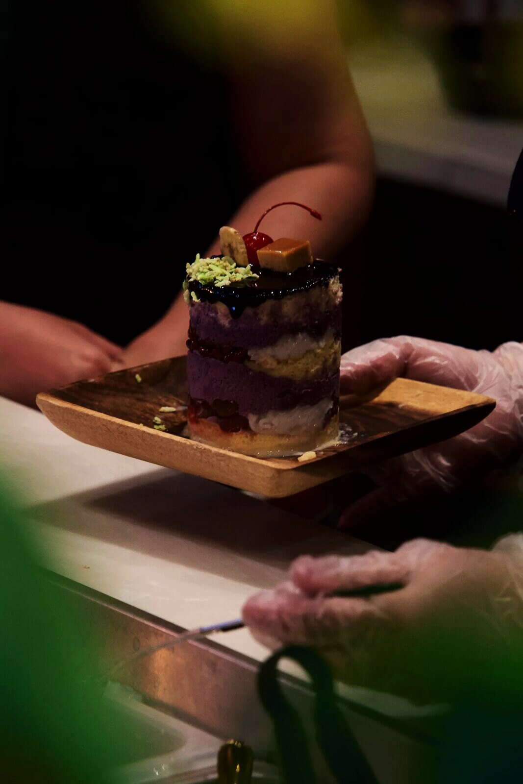 Chef plating an ube dessert at Purple Roots